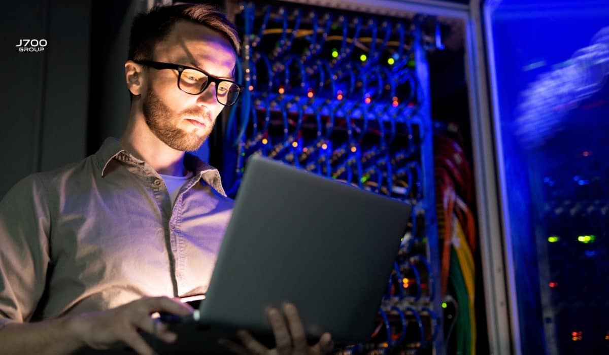 An IT technician making some checks in a sever room
