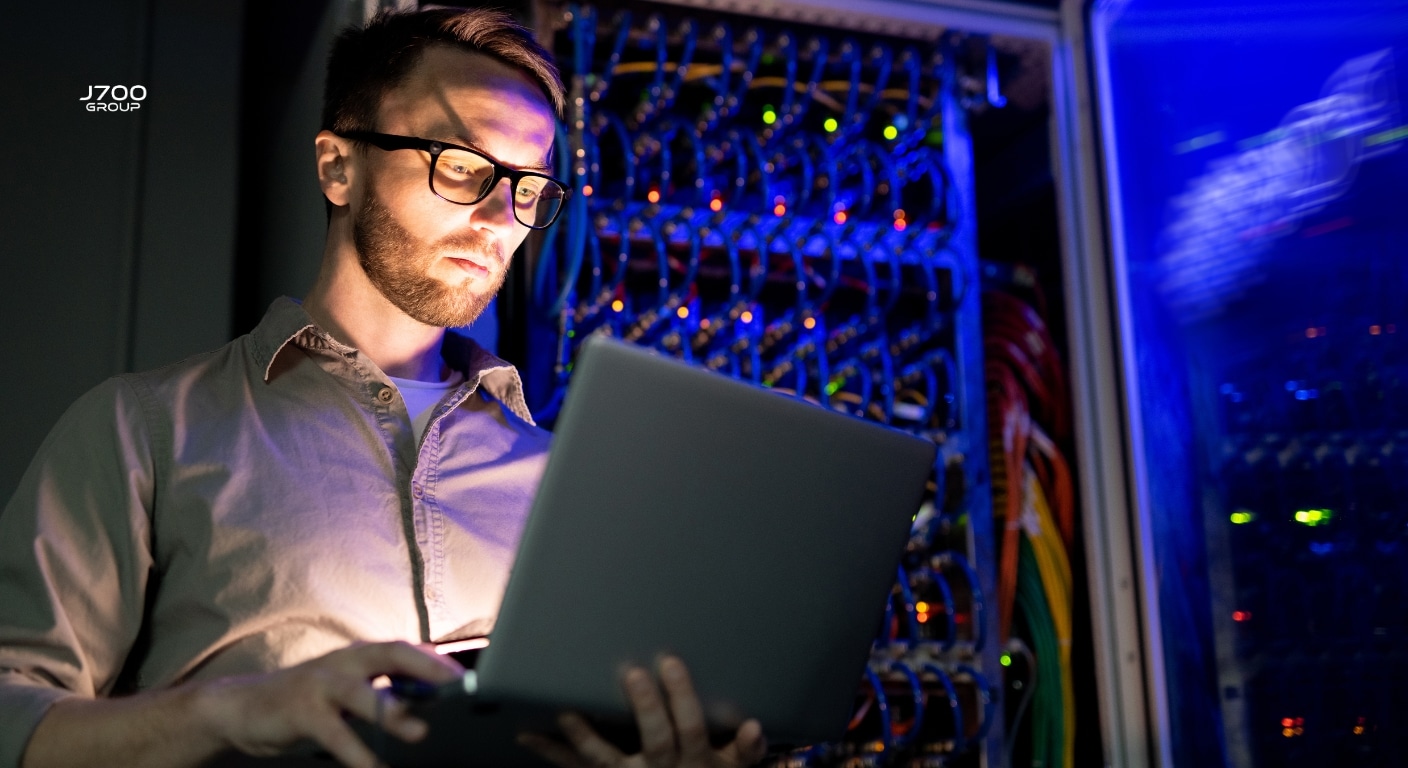An IT technician making some checks in a sever room