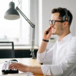 A professional in a North West office using smart communication, demonstrating how modern phone systems empower a hybrid business workforce.