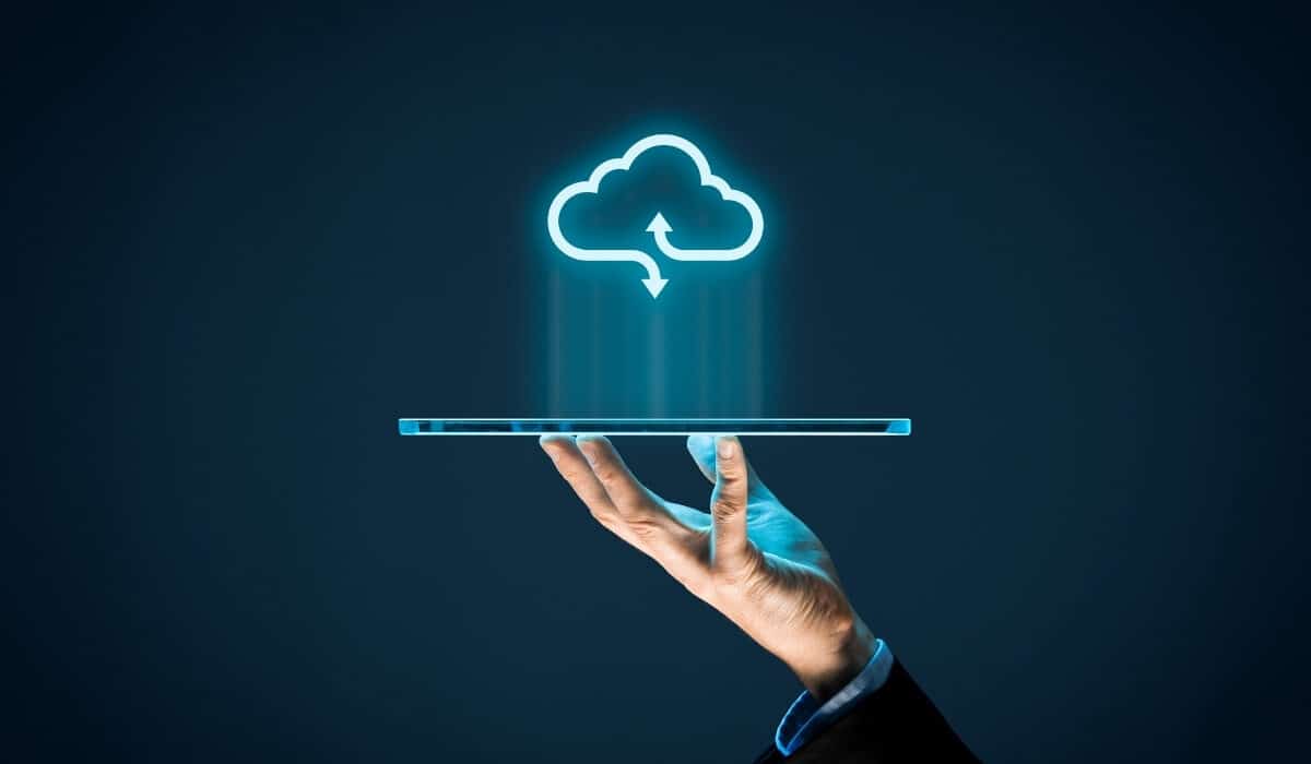 Conceptual image of a human hand holding a floating digital cloud, representing managed cloud services and IT strategy for businesses
