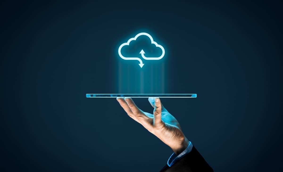 Conceptual image of a human hand holding a floating digital cloud, representing managed cloud services and IT strategy for businesses