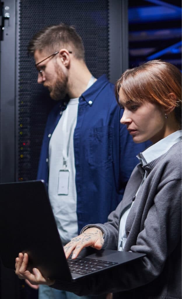 A dedicated IT technician working at a workstation, focused on resolving an IT issue for a client